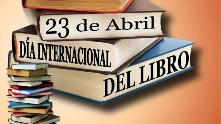Libros apilados y una vela encendida en homenaje al Día Internacional del Libro