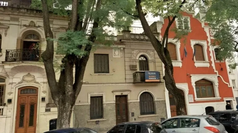 Fachada de la casona patrimonial en calle Belgrano 548, Rosario, con el Monumento a la Bandera en el fondo.