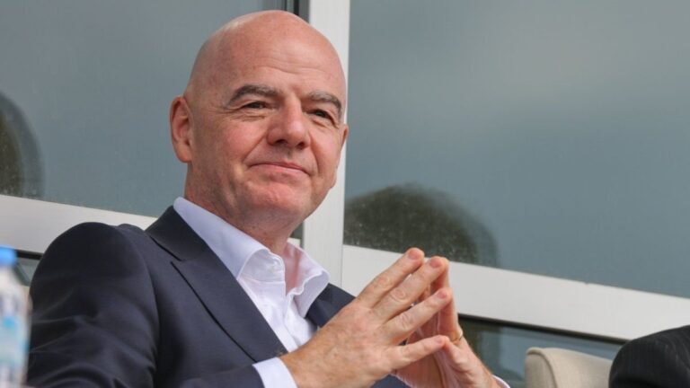 Gianni Infantino hablando con jugadores de Irán en el vestuario tras el partido